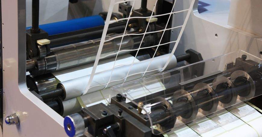 A machine removes the ladder (top) during the production of roll labels. 