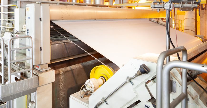 A web of paper material being processed in a paper mill plant.