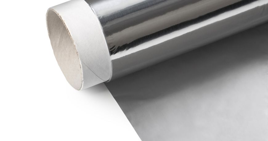 A partially unrolled roll of foil; the underside of the foil has a matt finish (unfolded section) compared to the gloss finish of the top side (on the roll).