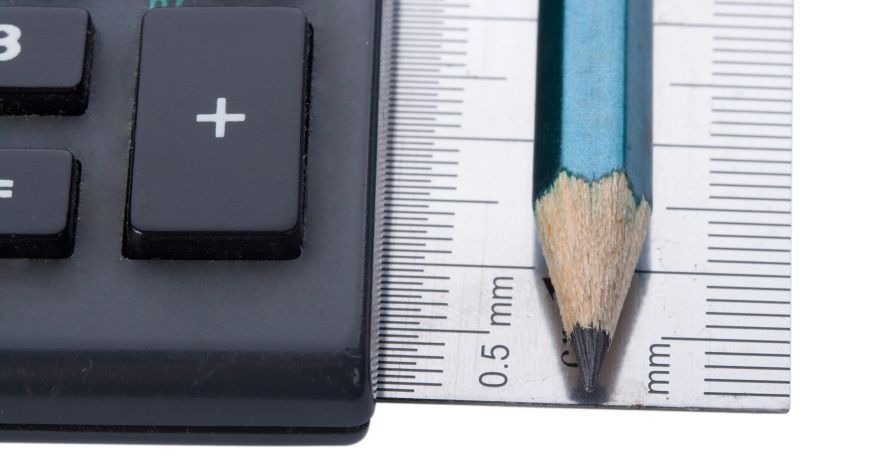 A pencil resting on top of a ruler; the ruler has markings that are designed to take measurements in millimetres.