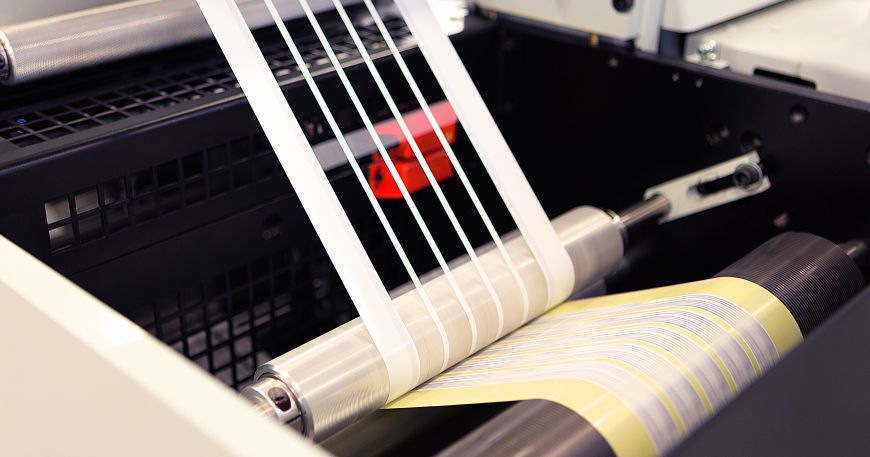 A machine removes the skeleton (top left) during the production of roll labels. 