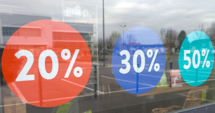 Three sale stickers applied onto the inside of a window. Static cling labels use static cling to hold a label in place instead of an adhesive and are a popular way to add labels or stickers to windows and other glass surfaces.