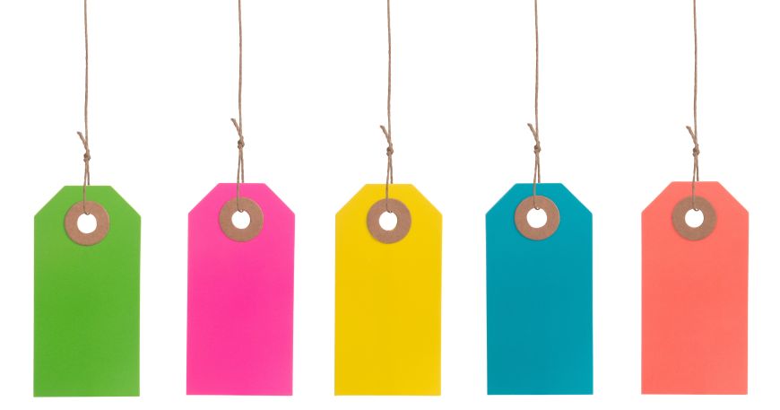 A selection of five colourful tag labels. A tag label is attached to an item using a thread or tie rather than an adhesive.