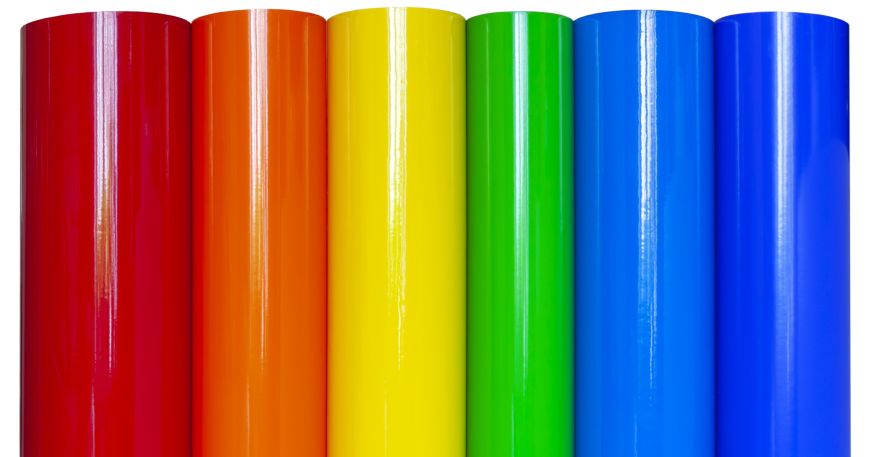 Rolls of vinyl film in a range of colours against a white background.