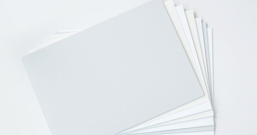 Various sheets of paper of different grades fanned out on a surface.