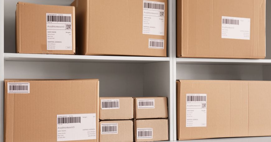 Shelves of parcels that have all been labelled with barcodes.