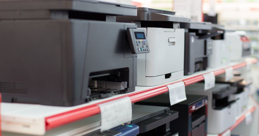 Shelves of desktop printers in a shop; all of the printers work using a form of digital printing.