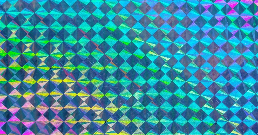 A close up of a sheet of holographic material; this example features a repeating grid pattern of square holograms.