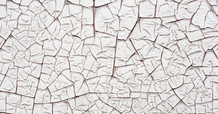 Alligatoring in a white surface coating; the coating shows a pattern of white cracks similar to reptilian skin - like that of an alligator.